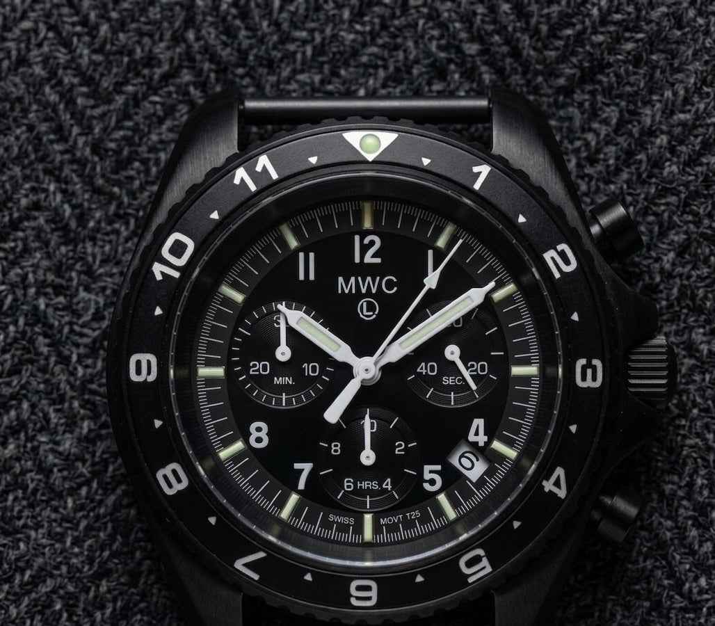 Cronógrafo de pilotos militares MWC patrón NATO de acero inoxidable con cristal de zafiro y movimiento suizo Ronda - Bisel GMT de 12 horas e iluminación GTLS/Tritio